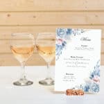 elegant wedding menu design placed on a rustic table with candlelight ambiance