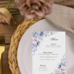 printable wedding menu card shown next to a plate with gold cutlery and linen napkin