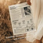 Bride holding boho beach wedding newspaper invitation in soft sand setting with QR codes and custom timeline.